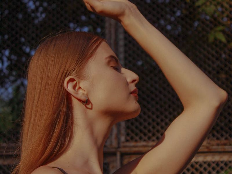 A person in a balanced pose against a clean, modern background.