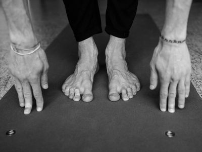 Close-up on hands during a stretching movement, showing concentration.